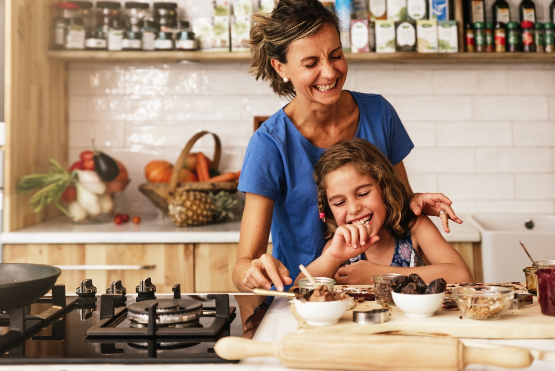 girl cooking with mother